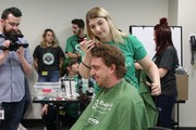 KACC Student Shaving hear of CSL Behring staff member for St. Baldrick's fundraiser